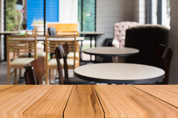 Selected focus empty brown wooden table and Coffee shop blur bac
