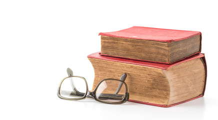 old book with glasses on white background