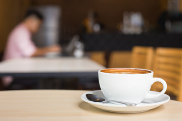 Hot art Latte Coffee in a cup on wooden table