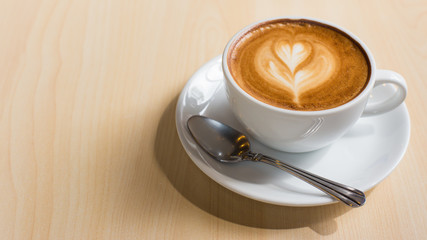 Hot art Latte Coffee in a cup on wooden table