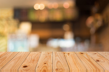 Selected focus empty brown wooden table and Coffee shop blur bac