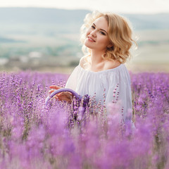 Beautiful woman in a field of blossoming lavender