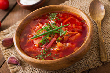 Traditional Ukrainian Russian vegetable borscht soup on the old wooden background