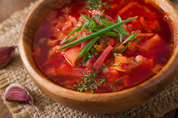 Traditional Ukrainian Russian vegetable borscht soup on the old wooden background
