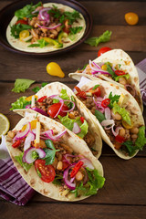 Mexican tacos with meat, beans and salsa