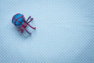 Blue thread spider on vintage blue fabric background