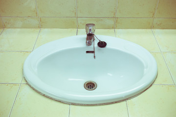 white wash sink in the bathroom with old silver faucet