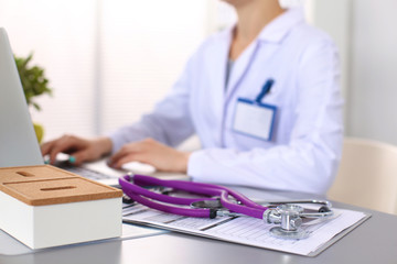 Portrait of happy medical doctor woman in office