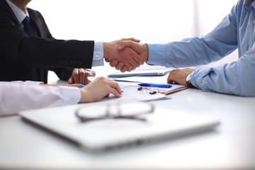 Image of business partners discussing documents and ideas at