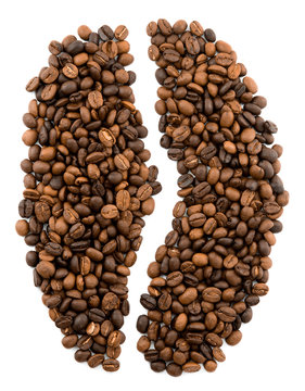 Roasted coffee beans placed in the shape of a group one coffee bean on a white surface