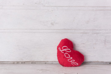 Red heart on grunge wood background