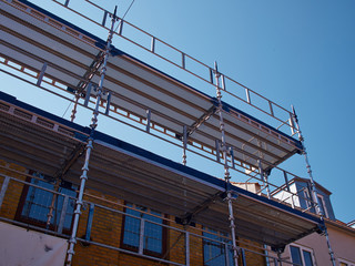 Fototapeta premium Scaffolds on a house building under renovations