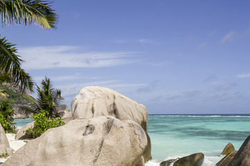 Fototapeta na wymiar Anse Source d'Argent, La Digue, Seychelles. It is the most beautiful tropical islands of the world's in the Indian Ocean. Big granite boulders rocks and palms leafs. 