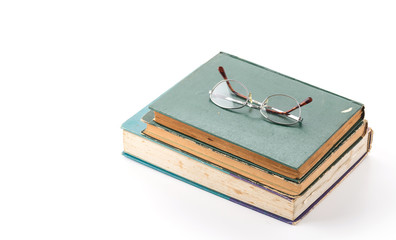 old book with glasses on white background