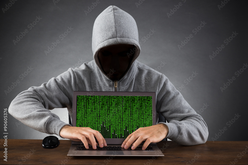 Poster man hacking laptop at desk