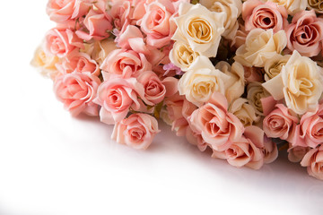 A bunch of roses lays on the white floor