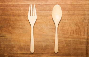 A dried wooden surface with a wooden spoon and fork