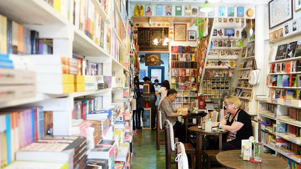 Tourist is in a bookshop, Thailand reading a book
