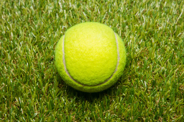 tennis ball on tennis grass court