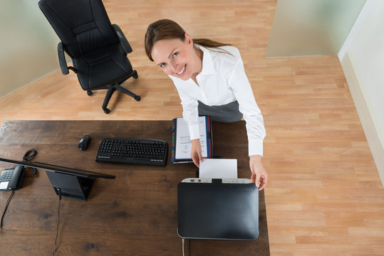 Young Businesswoman Using Printer In Office