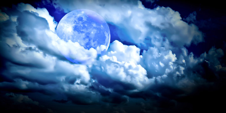 full blue moon in the clouds close up 