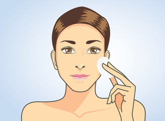 Beautiful woman cleaning face skin with facial cotton