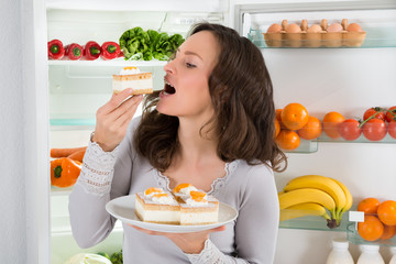 Woman Eating Slice Of Cake