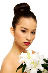 Fototapeta premium Beauty face of a woman with flower.
