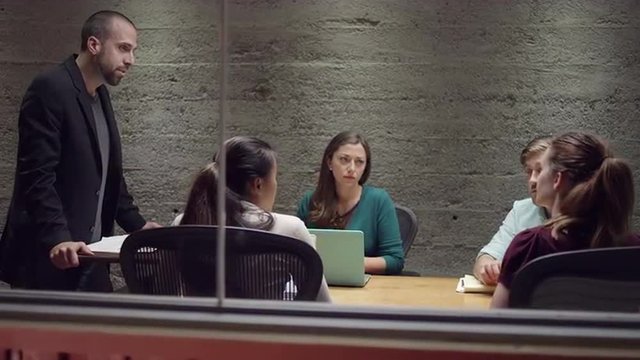 Angry man yelling in a small business meeting