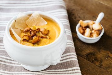 Pumpkin cream-soup with chanterelles, parmesan and croutons.