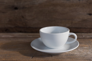 Cup of coffee on grunge wood table in vintage style,still life