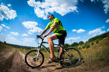 Fototapeta premium Athletic man with bicycle