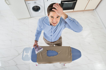 Man With Electric Iron And Burned Iron Cloth