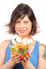 Natural girl eats salad with a bowl in hand