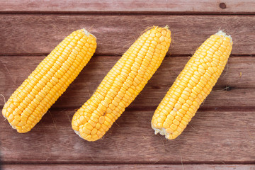 Fresh sweet corn on wooden table