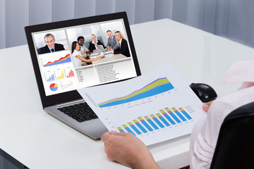 Businessperson Videoconferencing On Laptop - Powered by Adobe