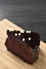 Chocolate soft cake on wood plate