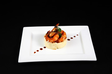 well dish with prawns in white plate