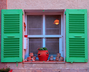 French rustic window with green wood shutters