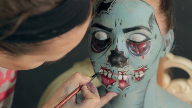 Halloween face art, application of make-up by makeup artist