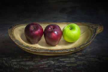 Still Life Apples on wooden bowl, dark tone background