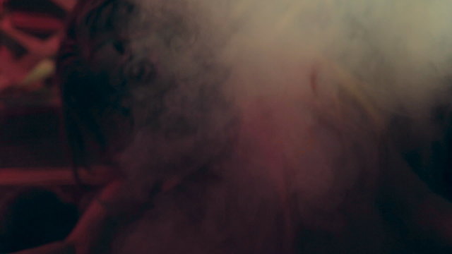 Creepy zombie in a coffin in the smoke