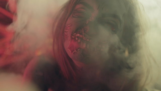 Scary horror movie with an awful zombie in smoke