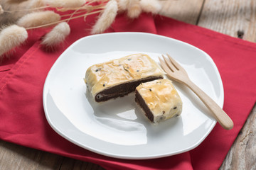 Chinese pastry, pie red bean with black sesame on white plate.