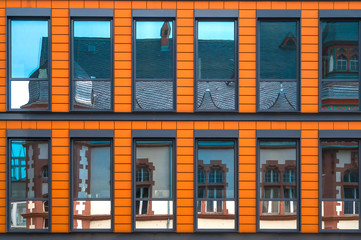 Naklejka premium bright facade close-up reflection in the windows of the old hous