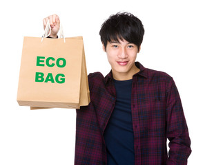 Happy Asian man shopper holding shopping bag for showing phrase