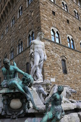 FLORENCE  statue of Neptune in the fountain and Palazzo Vecchio
