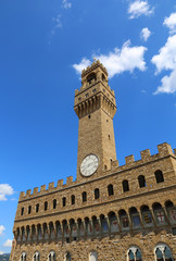 Obraz premium Old Palace with clock tower with blue sky in Signoria square in