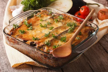 Wall murals meal dishes Greek moussaka closeup in baking dish and ingredients . horizontal  