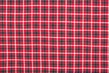 Scottish tartan pattern. Red and black plaid print as background. Symmetric square pattern.